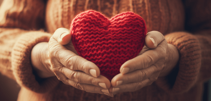 Hands holding a crocheted heart