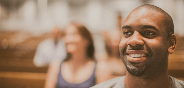 Smiling single person sitting in the pews