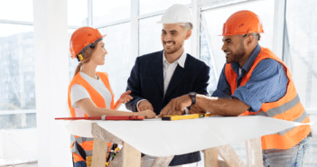 Construction workers looking over floorplans