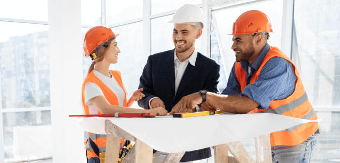 Construction workers looking over floorplans