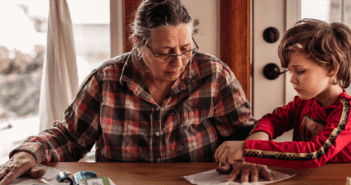 Older person and a child working on a craft together