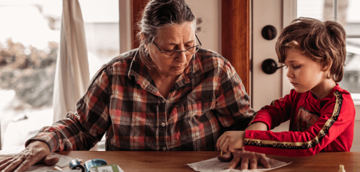 Older person and a child working on a craft together