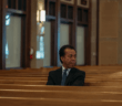 Person sitting alone in the pews
