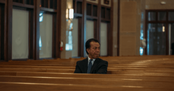 Person sitting alone in the pews