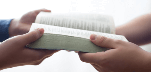 Passing a Bible from one person to another
