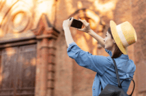 Happy person taking a photo of a church