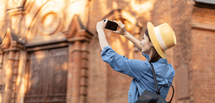 Happy person taking a photo of a church