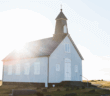 Small church with the sun peeking over the roof