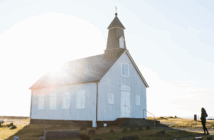 Small church with the sun peeking over the roof