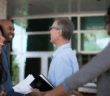 Smiling church members joyfully greeting and welcoming others at church