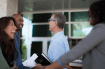 Smiling church members joyfully greeting and welcoming others at church