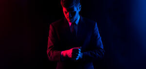 Person lit on one side by blue light and on the other side by red light