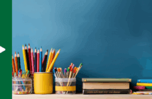 Photo of many colored pencils and books atop a desk
