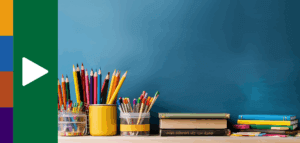 Photo of many colored pencils and books atop a desk