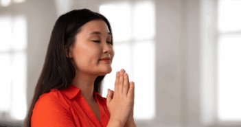 8 Ways Your Inward Journey Can Ground Your Outward Action A person praying in a church sactuary