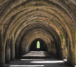 View that looks far down the pathway through a series of old stone arches