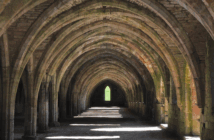 View that looks far down the pathway through a series of old stone arches