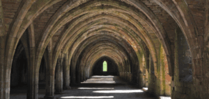 View that looks far down the pathway through a series of old stone arches