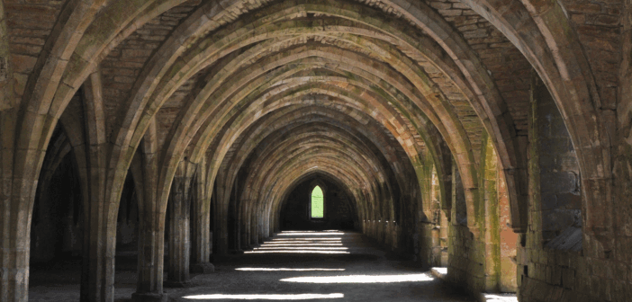 View that looks far down the pathway through a series of old stone arches