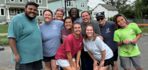 Group photo of smiling adults and young people wearing t-shirts with the Cross Connection logo