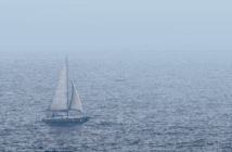 Sailboat on choppy waters in the fog