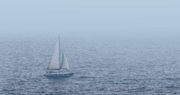Sailboat on choppy waters in the fog