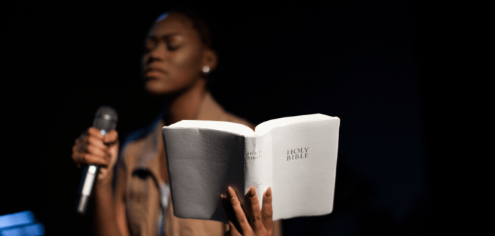 Female pastor holding the Bible