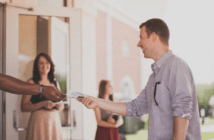 Person being greeted at church by ushers