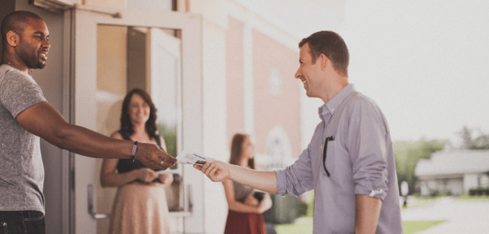 Person being greeted at church by ushers