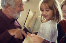Pastor pointing out a passage in a children's Bible
