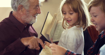 Pastor pointing out a passage in a children's Bible