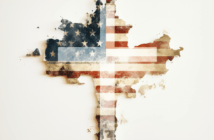 Christian cross in front of a tattered American flag