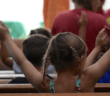 Enthusiastic children sitting in the pews during the children's sermon