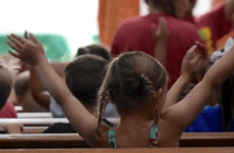 Enthusiastic children sitting in the pews during the children's sermon