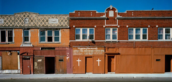 Sidewalk view of Huggins Community African Methodist Episcopal Church and attached buildings in Detroit, Michigan