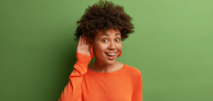 Excited person cupping their ear to better hear what you have to say
