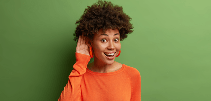 Excited person cupping their ear to better hear what you have to say