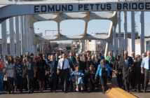 President Obama, congressman John Lewis, former President George W. Bush, and Civil Rights Movement veterans and other commemoration attendees marching across the Edmund Pettus Bridge in March 2015.