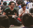 Youth sitting on the floor in circles laughing and enjoying snacks together