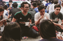 Youth sitting on the floor in circles laughing and enjoying snacks together