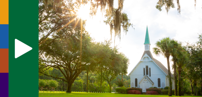 Rural church with bright sunshine filtering through the surrounding trees