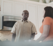 Smiling people in the kitchen at an informal church gathering in someone's house