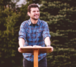 Friendly younger pastor preaching a sermon outdoors