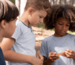 Group of kids looking carefully at a note