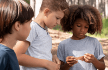 Group of kids looking carefully at a note