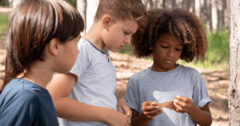 Group of kids looking carefully at a note