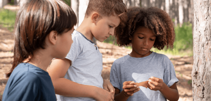 Group of kids looking carefully at a note
