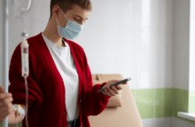Hospital patient listening to a voicemail on their cell phone