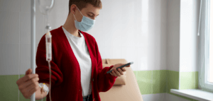 Hospital patient listening to a voicemail on their cell phone