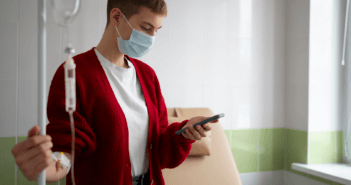 Hospital patient listening to a voicemail on their cell phone